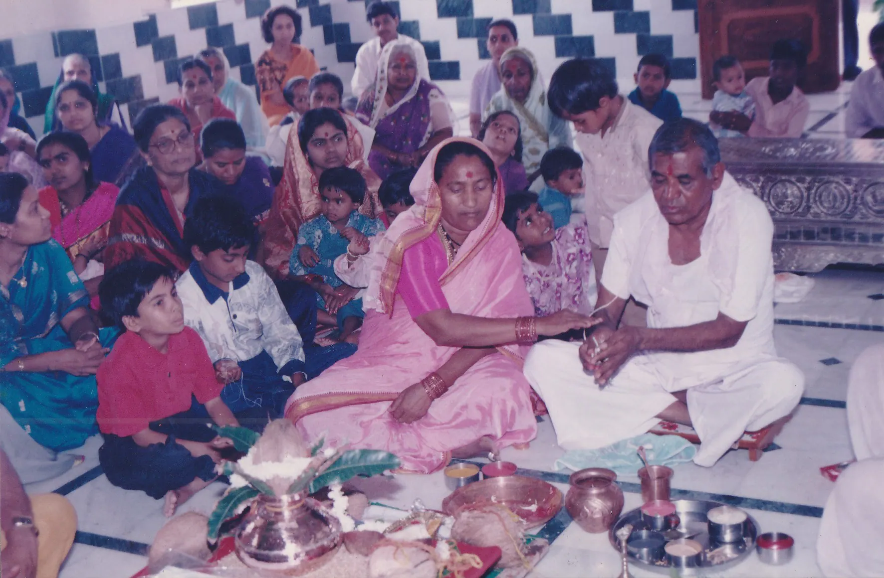Param Pujya Shri Dhondiram Baba Chavan seated with devotees during a puja gathering