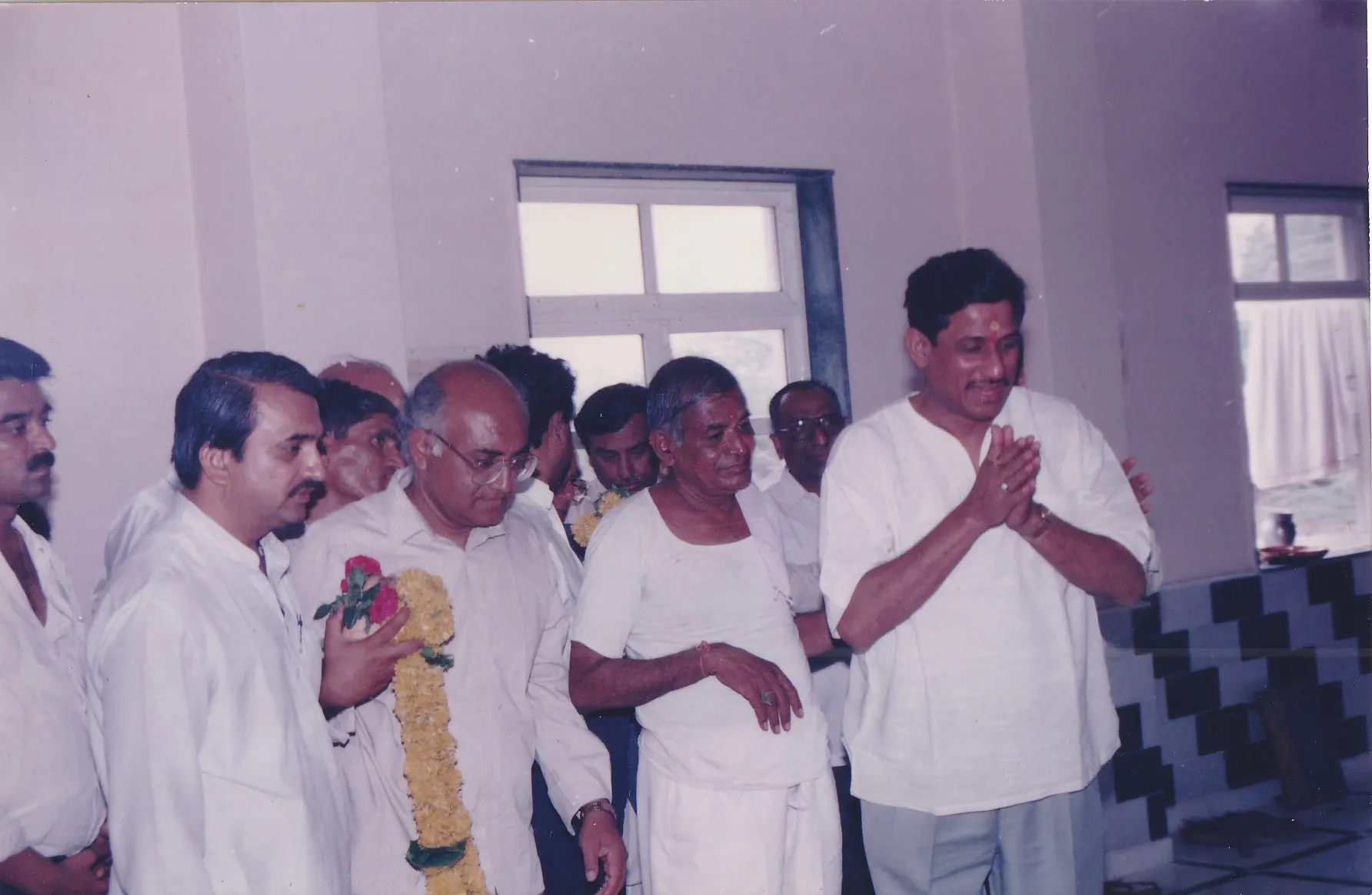 Param Pujya Shri Dhondiram Baba Chavan standing with devotees during a prayer gathering