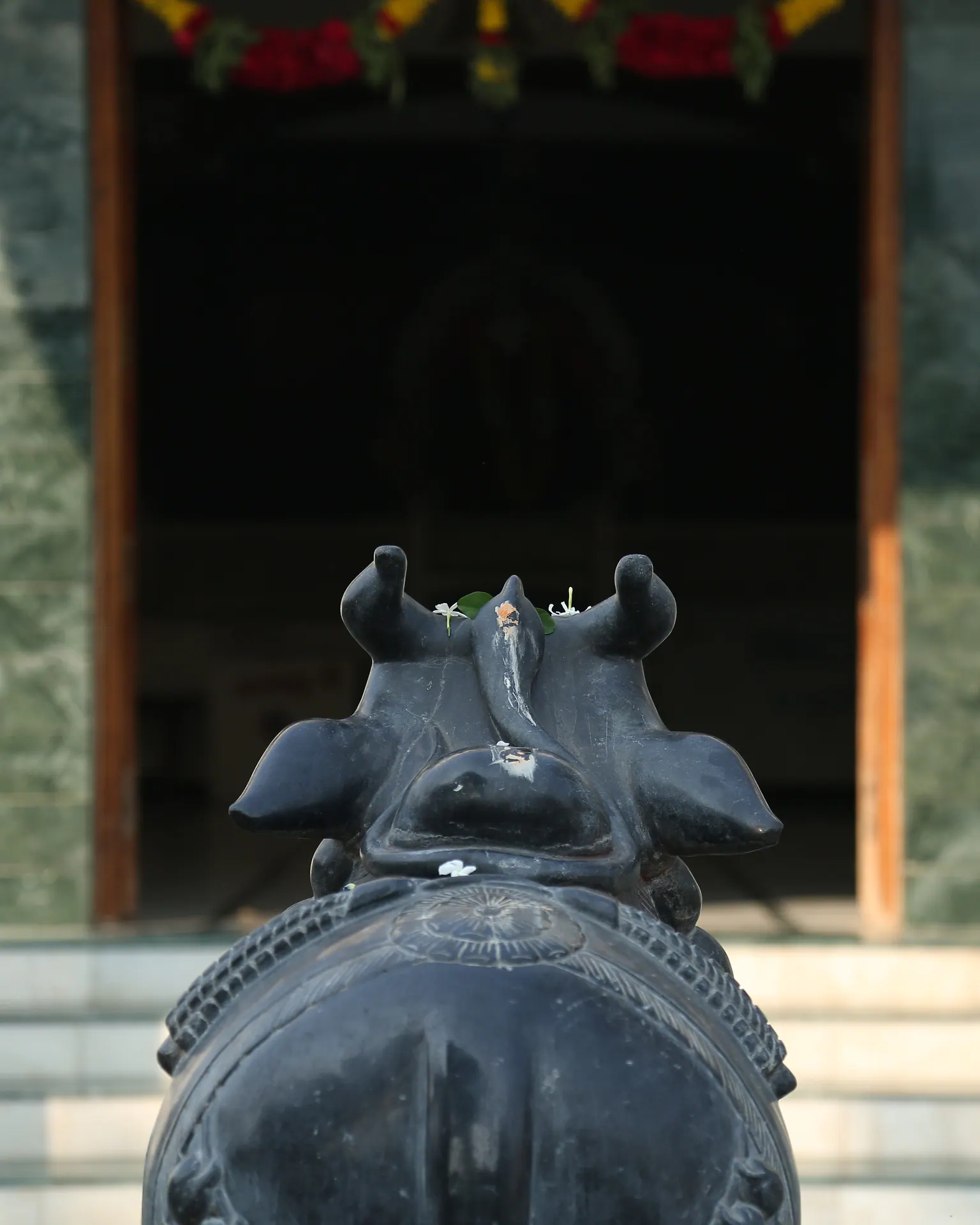 Nandi sculpture facing the Saidham Mandir entrance